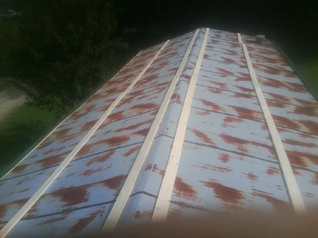 Rusted metal roof panels with new wood purlins before replacement — Storm Damage Roof Repair in Rio Rancho by Roofing Brothers